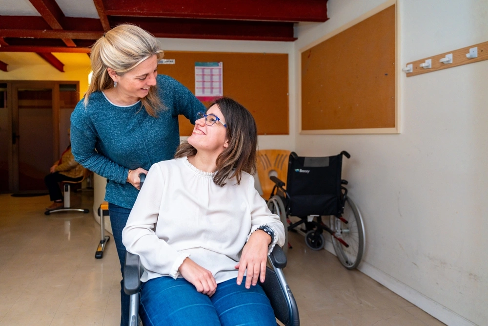 women on wheelchair with care taker