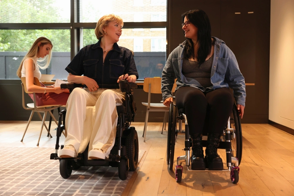 Two disabled women on wheelchair chatting